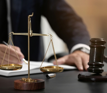 scales of justice and gavel on desk